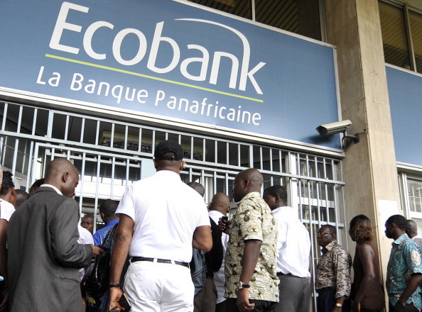 People wait in line on February 16, 2011 in front of a branch of the pan-African bank Ecobank in Abidjan. The Ivorian offices of two international banks, French BNP Paribas and US Citibank, were closed of February 14 after the west African regional bank BCEAO warned banks they risked sanctions if they dealt with Laurent Gbagbo's disputed regime. Gbagbo threatened on February 15 to take legal action against foreign banks Citibank and BNP Paribas after they closed their offices in the country. AFP PHOTO / SIA KAMBOU (Photo credit should read SIA KAMBOU/AFP/Getty Images)